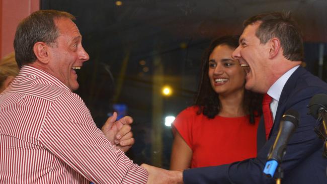 Former Labor backbencher Jeff Collins, left, congratulates Labor leader Michael Gunner on becoming the NT's new Chief Minister on NT election night. Picture: Ivan Rachman