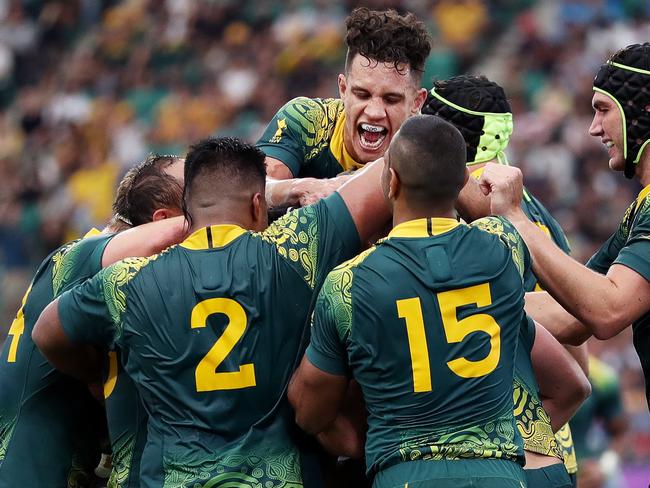 OITA, JAPAN - OCTOBER 05: James Slipper (obscured) of Australia is congratulated by his team mates after scoring his side's sixth try during the Rugby World Cup 2019 Group D game between Australia and Uruguay at Oita Stadium on October 05, 2019 in Oita, Japan. (Photo by Dan Mullan/Getty Images)