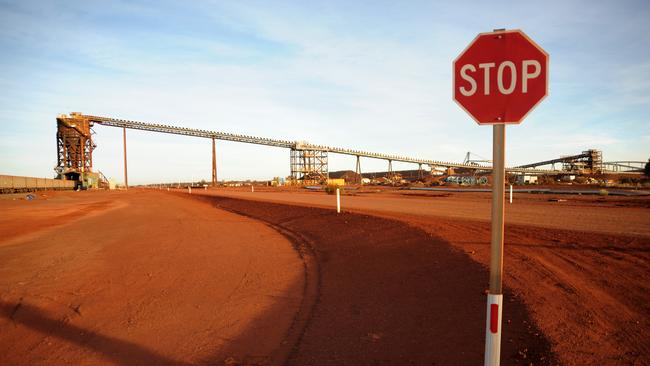 A stop sign stands at the entrance to the crushing facility at Fortescue Metals Group, Cloudbreak Iron Ore operation in Cloudbreak in Western Australia, on Monday, Jul. 25, 2011. Photographer: Carla Gottgens/Bloomberg