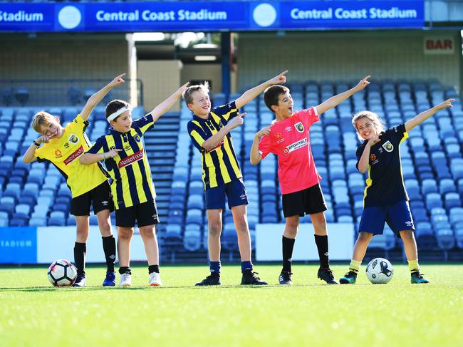 Jeremy Pegler, 10, Dom White, 10, Kaden Learnmonth, 10,  Cooper Pegler, 11 and Ruby Govind-Aley, 10 are excited about Usain Bolt arriving and play on the Central Coast Mariners home field at Gosford. Picture: Adam Taylor