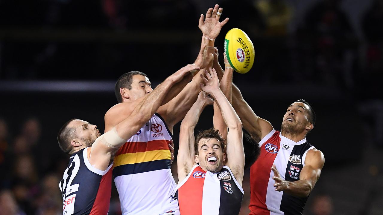 Taylor Walker of the Crows attempts to mark over Nathan Brown, Daniel McKenzie and Shane Savage of the Saints. Picture: Quinn Rooney/Getty Images