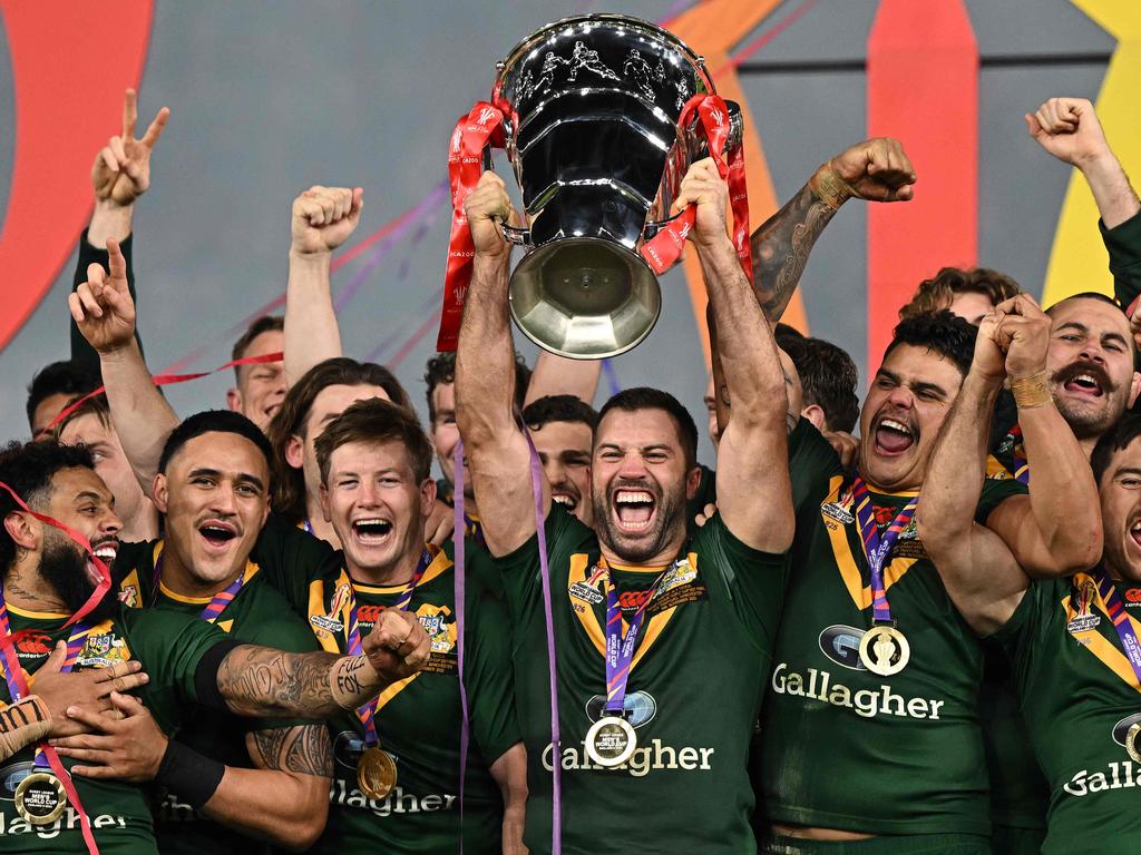 Australia's James Tedesco lifts the trophy during winner's presentation ceremony after Rugby League World Cup Men's final between Australia and Samoa at Old Trafford stadium, in Manchester, on November 19, 2022. – Australia won the match 30-10. (Photo by Oli SCARFF / AFP)