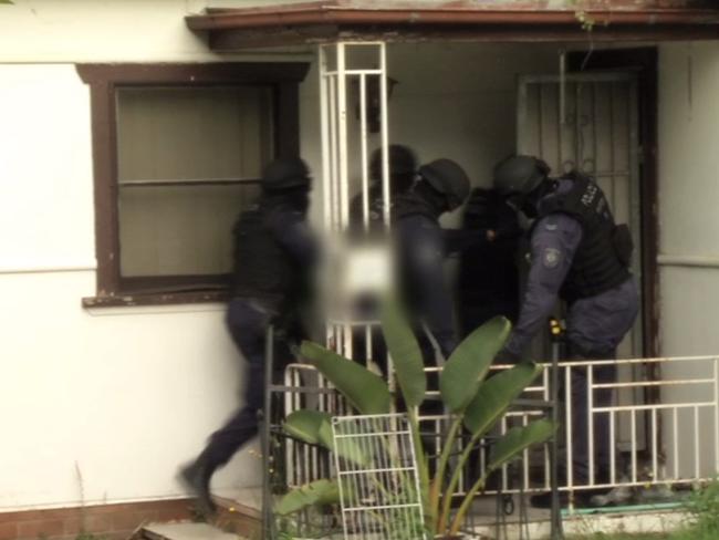 Strike back ... Strike Force Raptor officers raid a home in Sydney. Photo: NSW Police