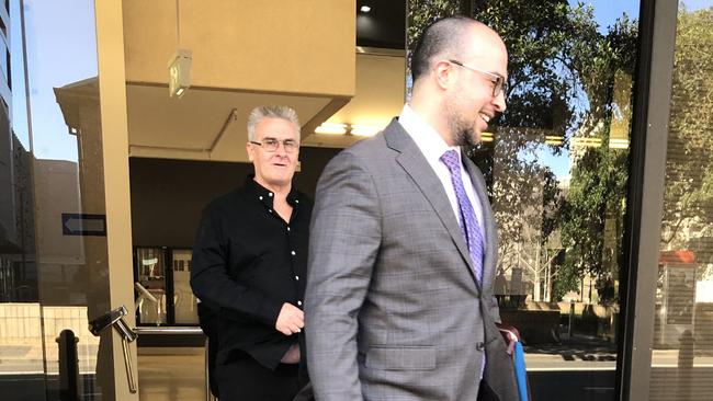 TREVOR BISTISI (back) leaves Parramatta Local Court with his lawyer.