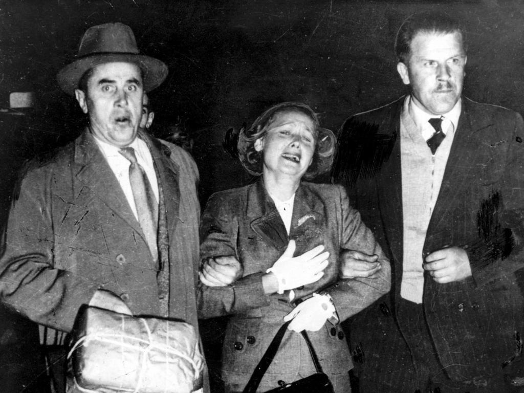 Wailing Russian defector Evdokia (Eva) Petrov, flanked by Soviet courier Valery Karpinsky and an embassy driver, at Sydney Airport on April 19, 1954, as she approaches the plane that was to have taken her to Moscow.