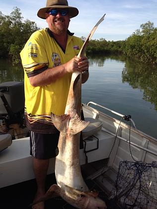 Paul van Bruggen removes a large 1.5-2m shark that he caught in his crab pot along the Elizabeth River. 