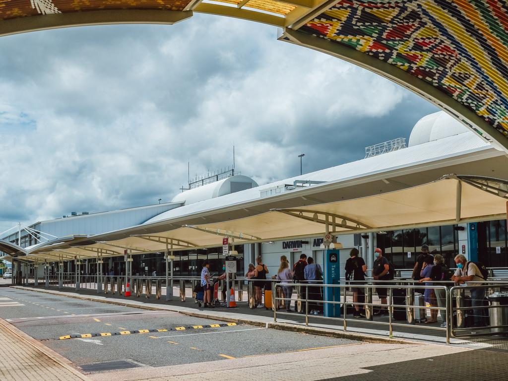 Travellers arriving in Darwin waiting for up to 20 minutes for a taxi at Darwin International Airport. Picture: Glenn Campbell