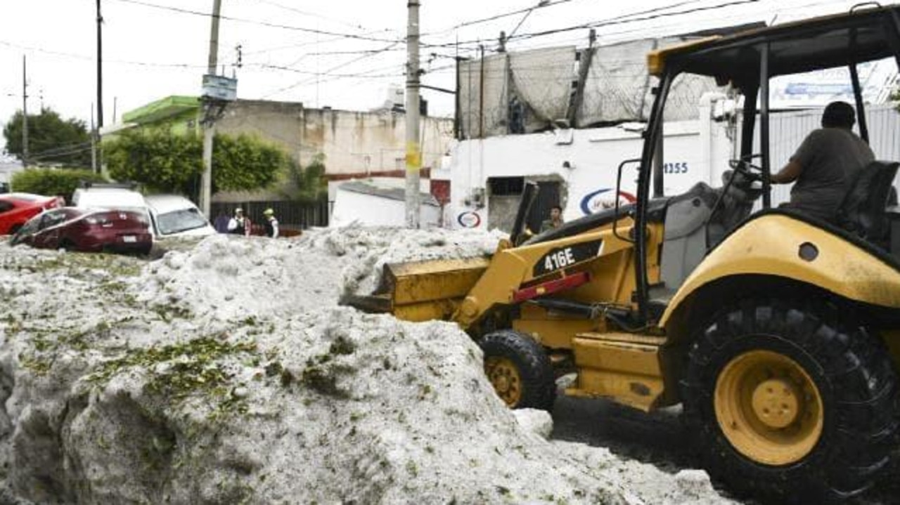 A bulldozer is used to remove the hail. Picture: Jalisco State Civil Defense Agency via AP