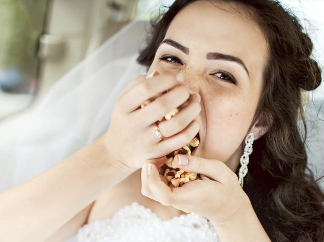 Beautiful bride sitting in car straight with mobile phone hairstyle and bright makeup