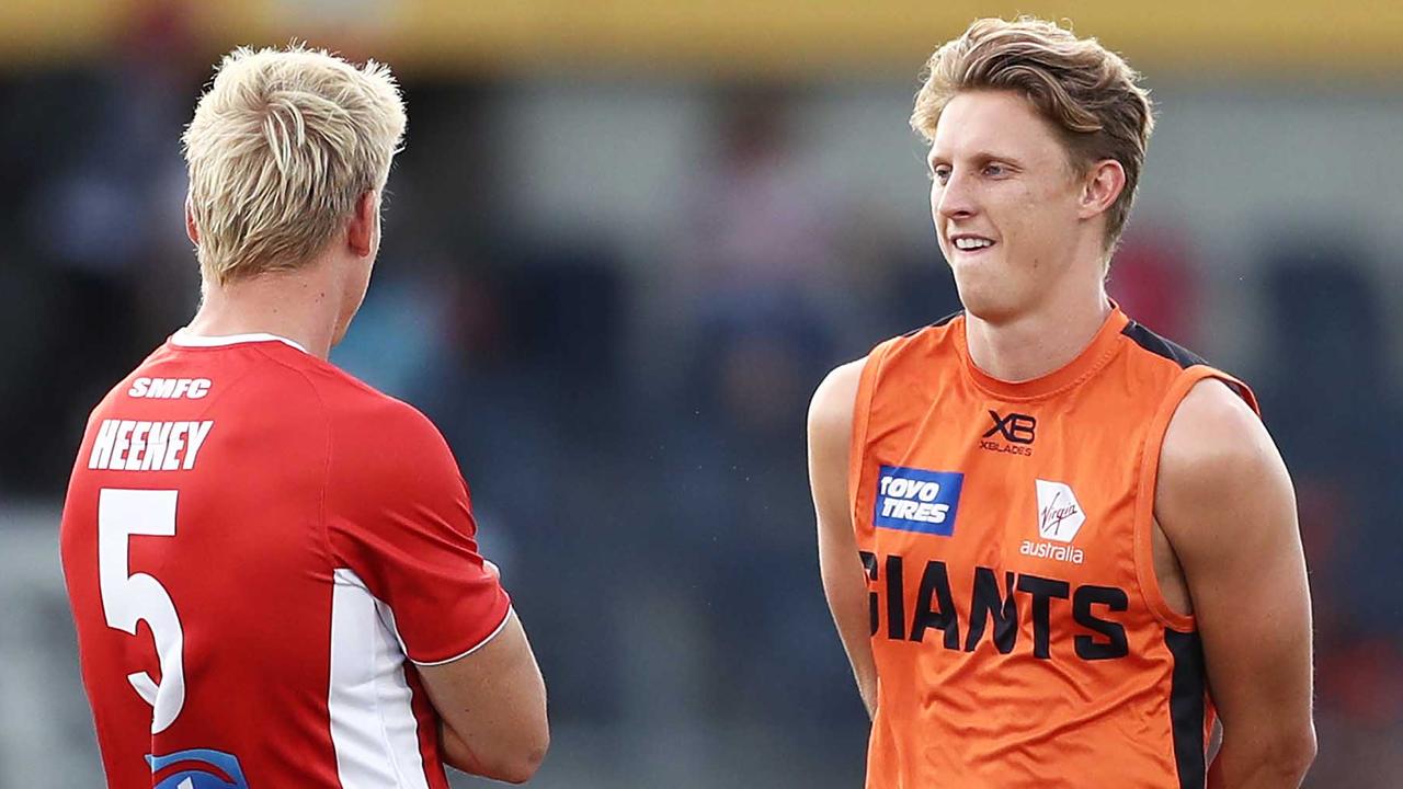 Giant Lachie Whitfield, right, chats to Swan Isaac Heeney during the JLT Series.