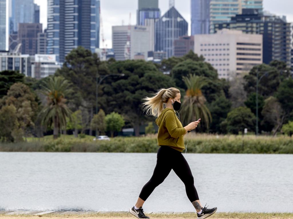 A woman walks around Albert Park Lake during Melbourne’s sixth Covid lockdown. Picture: David Geraghty