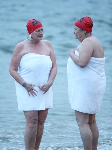 Debriefing near the water’s edge after the swim. Picture: NIKKI DAVIS-JONES