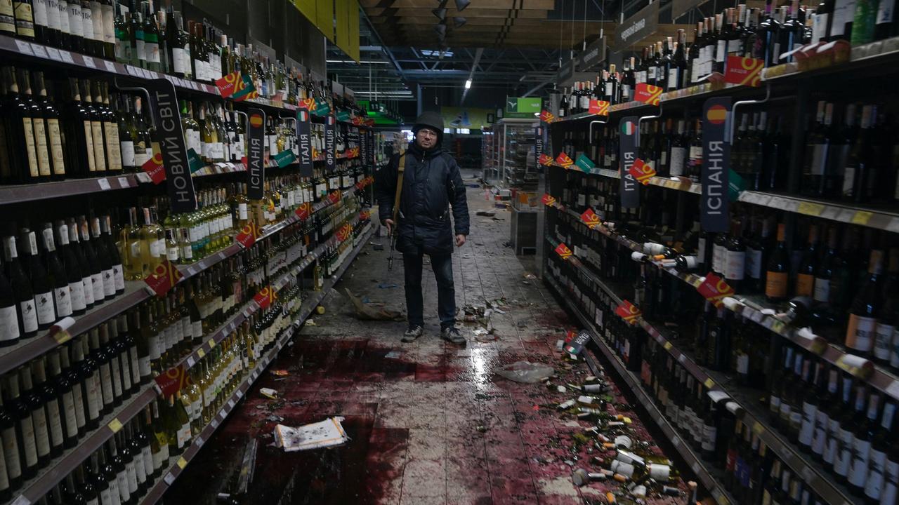 A member of the Ukrainian Territorial Defence Forces stands inside a supermarket in the town of Bucha in the Kyiv region, Ukraine. Picture: Maksim Levin