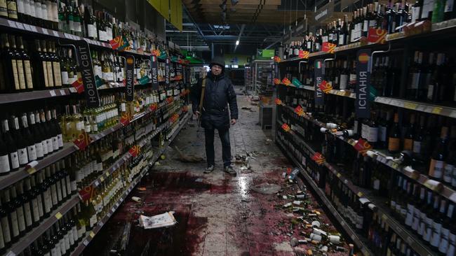 A member of the Ukrainian Territorial Defence Forces stands inside a supermarket in the town of Bucha in the Kyiv region, Ukraine. Picture: Maksim Levin