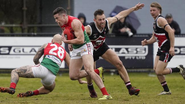 MPNFL: Pines’ Luke Dalmau tries to slip a Bonbeach tackler. Picture: Valeriu Campan