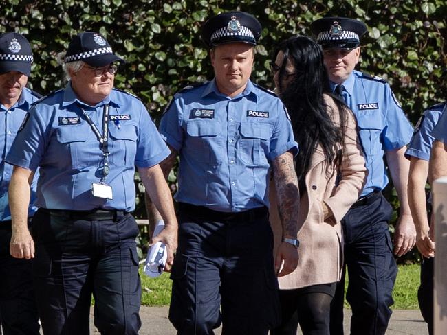 Constable Brent Wyndham (4th L) arrives to  give evidence at the inquest into the death of Aboriginal woman Joyce Clarke. Wyndham shot and killed Clarke in the regional West Australian town of Geraldton. Picture: Graeme Gibbons