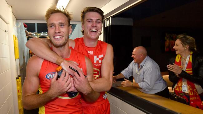 Jack Hombsch (left) and Charlie Ballard (right) of the Suns celebrate after winning the Round 2 match against the Dockers at Metricon Stadium. Picture: AAP Image/Darren England