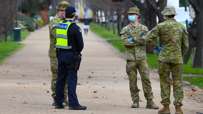 Police officers and soldiers patrol Melbourne after stage four restrictions were introduced. Picture: AFP