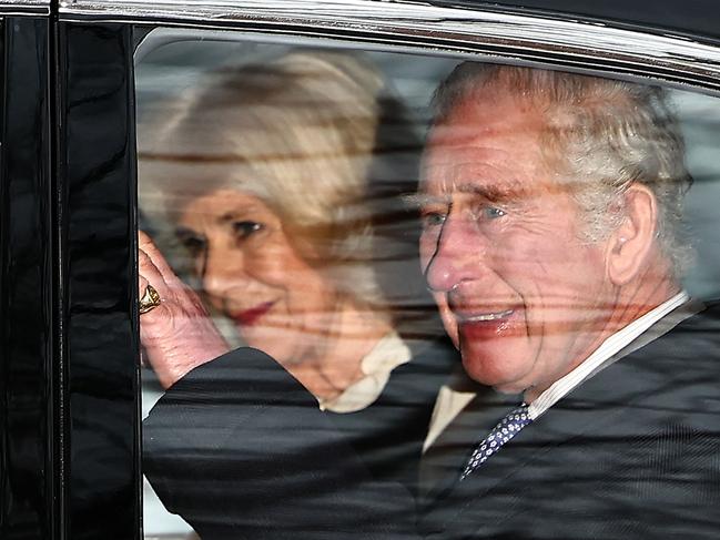 Britain's King Charles III and Britain's Queen Camilla wave as they leave by car from Clarence House in London on February 6, 2024. King Charles III's estranged son Prince Harry reportedly arrived in London on Tuesday after his father's diagnosis of cancer, which doctors "caught early". (Photo by HENRY NICHOLLS / AFP)