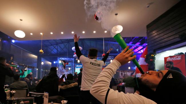 Palestinian fans in the West Bank city of Ramallah react as they watch a large screen showing their team playing during the 2019 AFC Asian Cup Group B football match against Syria. Picture: AFP