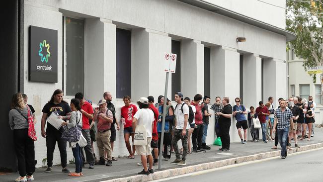 A long line outside and around the corner at Fortitude Valley Centrelink in March. Photographer: Liam Kidston.