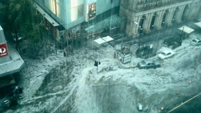 An almost apocalyptic image from a 2010 flood as rain crashes down on Melbourne’s CBD.