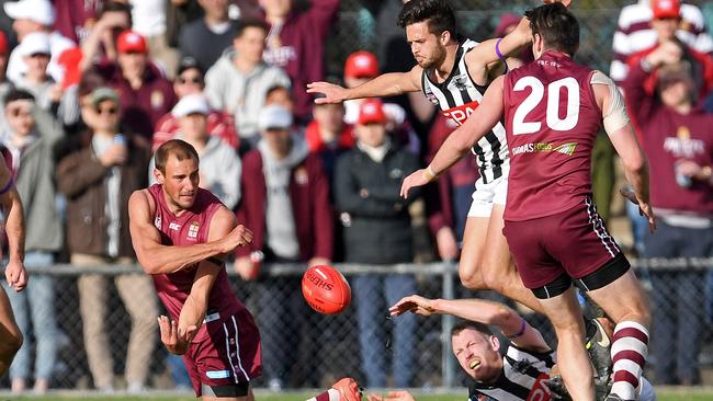 Prince Alfred Old Collegians’ Will Dalwood tries to get a handball away during the Adelaide Footy League division one grand final. Picture: Tom Huntley