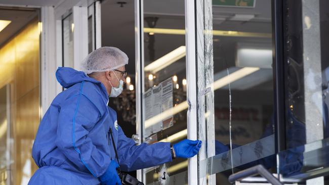 Police forensic officer at Barolos restaurant.