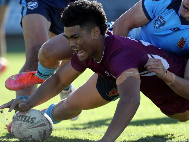 QLD's Karl Oloapu scores a try whilst NSW's Chevy Stewart attempts to tackle during the under 18 ASSRL schoolboy rugby league championship grand final between QLD v NSW CHS from Moreton Daily Stadium, Redcliffe.  Picture: Zak Simmonds