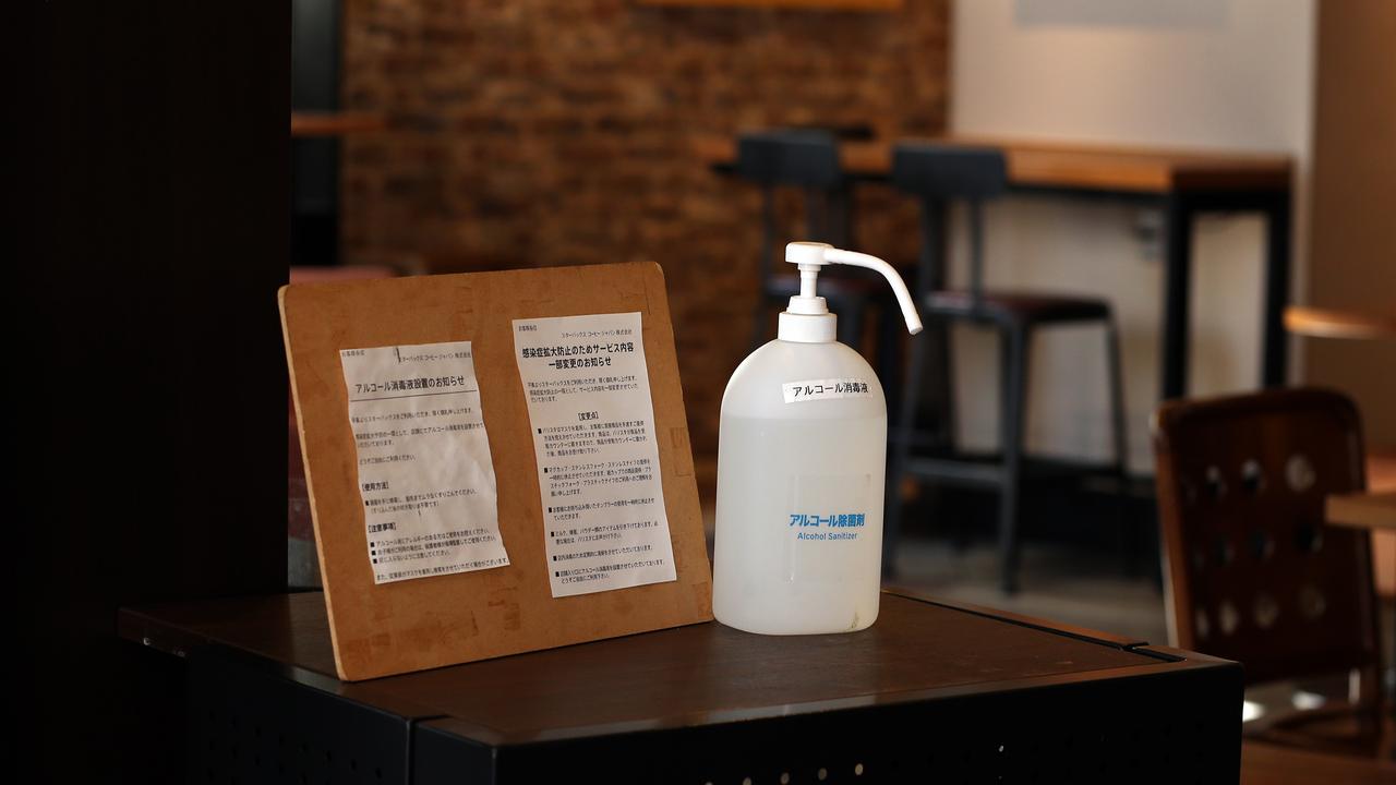 A bottle of hand sanitisers with notice is placed at the entrance of a restaurant outside the Universal Studio station on March 05, 2020 in Osaka, Japan. Picture: Buddhika Weerasinghe