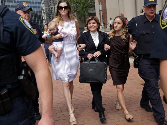 Teala Davies, right, lawyer Gloria Allred, centre, and an unidentified accuser and her baby leave the court. Picture: AFP