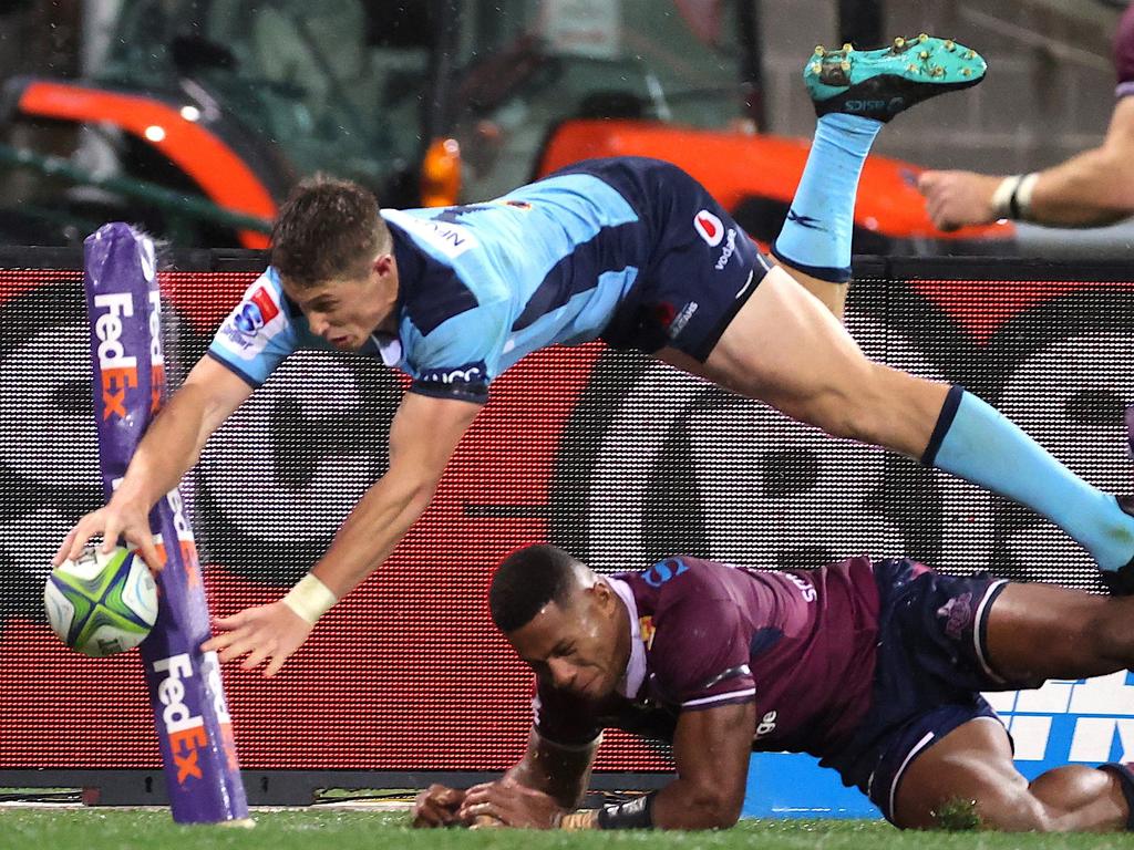 Alex Newsome dives over for the New South Wales Waratahs.