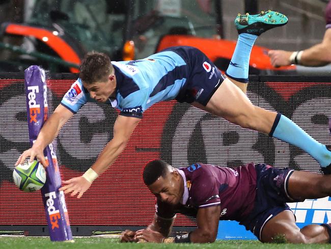 Alex Newsome dives over for the New South Wales Waratahs.