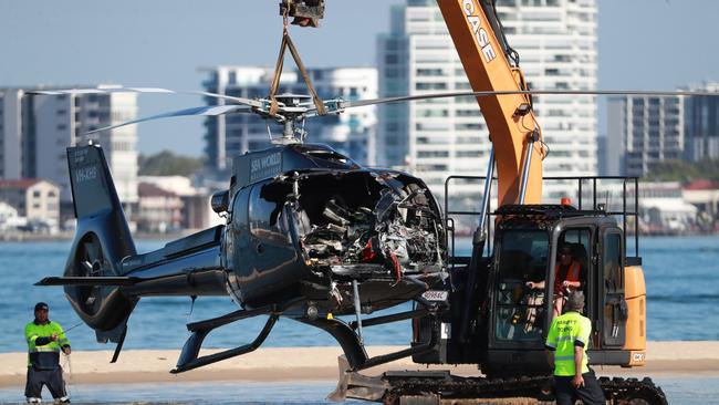 Queensland Police and ATSB Officers recover the wreckage after four people were killed when two helicopters collided near Sea World. Picture Scott Powick