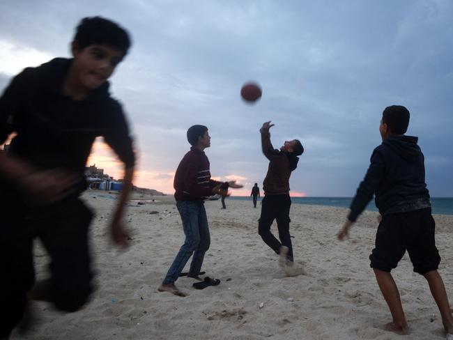 Palestinian children start a ball game. Picture: AFP