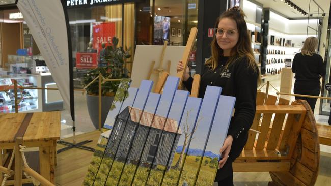 POP-UP PALLETS: Toowoomba Hospital Foundation’s Emma Manteufel stands with one of the artworks available for auction. Picture: Rhylea Millar