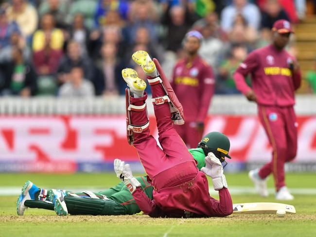 Bangladesh's Liton Das and West Indies' Shai Hope collide in an unsuccessful attempted run out. Picture: Saeed Khan/AFP