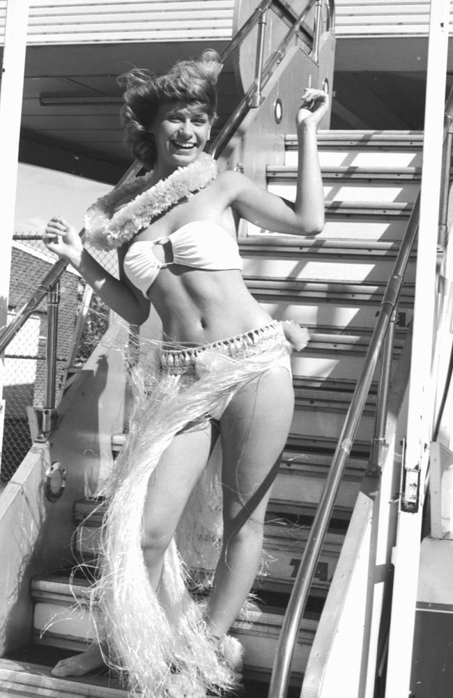 Miss Tasmania 1981 Angela Potter wearing a traditional grass skirt on the steps of the plane at Hobart Airport before leaving for Honolulu. Picture: Fred Kohl