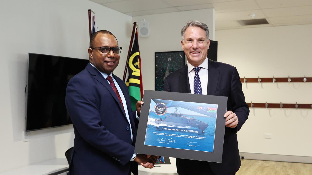 Vanuatu Minister of Internal Affairs Andrew Solomon Napuat and Australian Deputy Prime Minister and Defence Minister Richard Marles exchange certificates to commemorate the recommissioning of the RVS Takuare. Picture: Brendan Radke