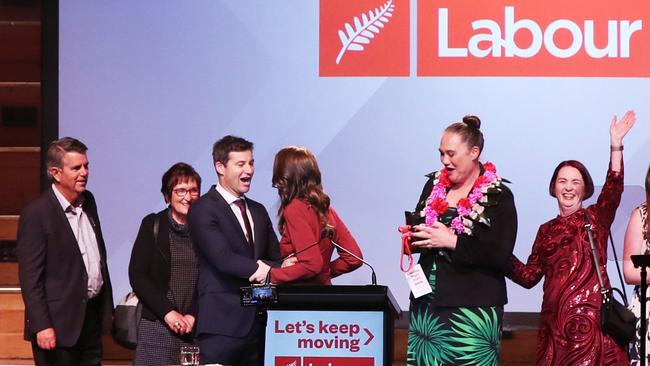 New Zealand Prime Minister Jacinda Ardern (C), her husband Clarke Gayford (centre L) and party members celebrate their win. Picture: AFP