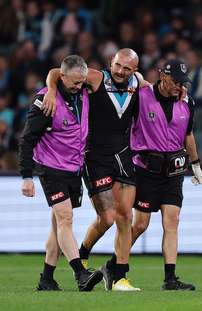 Sam Powell-Pepper is helped from the field in Round 7. Picture: Sarah Reed/AFL Photos via Getty Images.