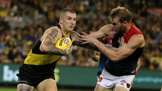 Dustin Martin fends off Jack Watts. Picture: Wayne Ludbey