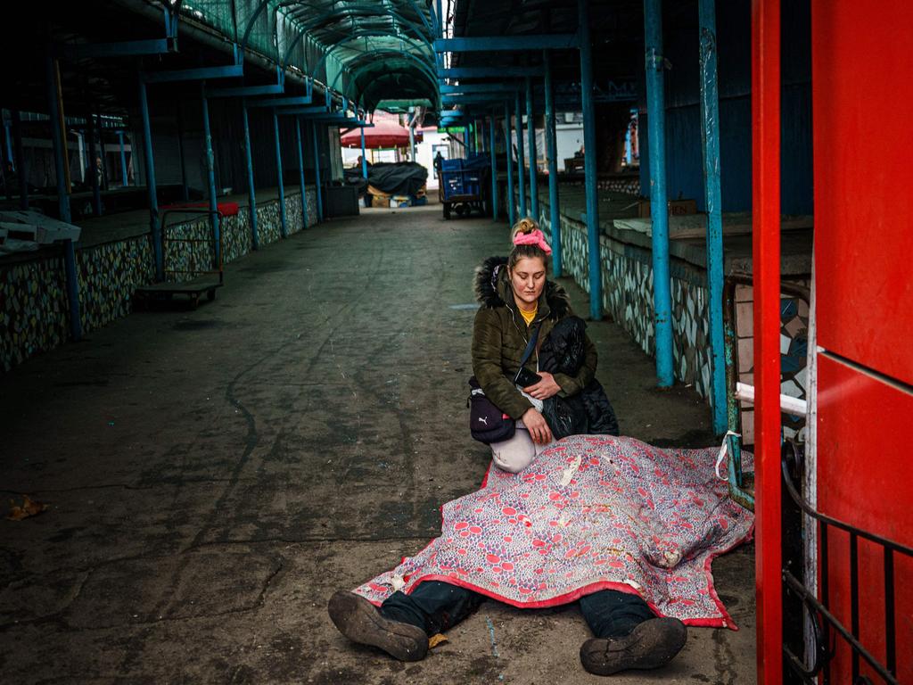 A woman next to the body of her dead husband after Russian shelling to Ukrainian city of Kherson here five were killed and 20 injured. Picture: AFP