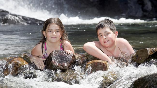 Danielle and Damien Ross-Jarry enjoy a dip at Cedar Creek Falls. Picture: David/Clark