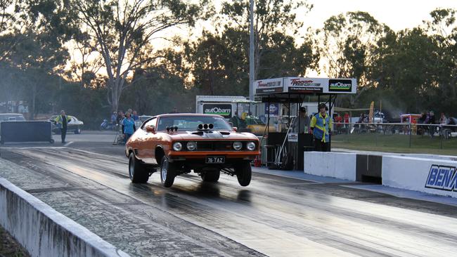 Gladstone's Brett Kelly gets the front wheels off the ground in his Ford Falcon coupe on the way to a low 10 second pass at Benaraby Dragway. Picture: Rodney Stevens