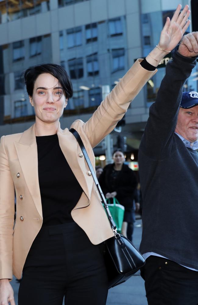 Sarah Budge leaves the Downing Centre and hails a taxi with her dad on Tuesday. Picture: Christian Gilles