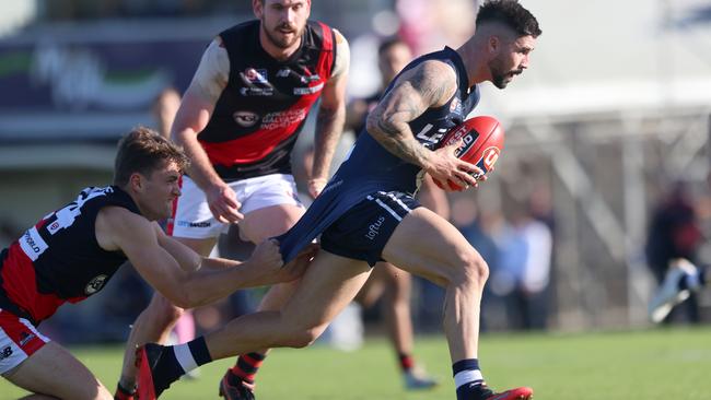 Goalbound South Adelaide forward Eamon Wilkinson is tackled by West Adelaide’s Sam May at Noarlunga Oval on Saturday. Picture: Cory Sutton/SANFL.