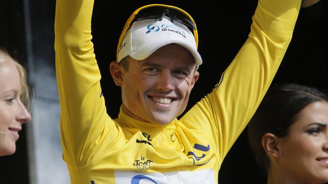 Simon Gerrans pulls on the yellow jersey at last year’s Tour de France.