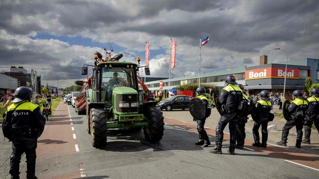 Farmers remove tractors forming a blockade during a demonstration against the Dutch government's far-reaching plans to cut nitrogen emissions. Picture: AFP