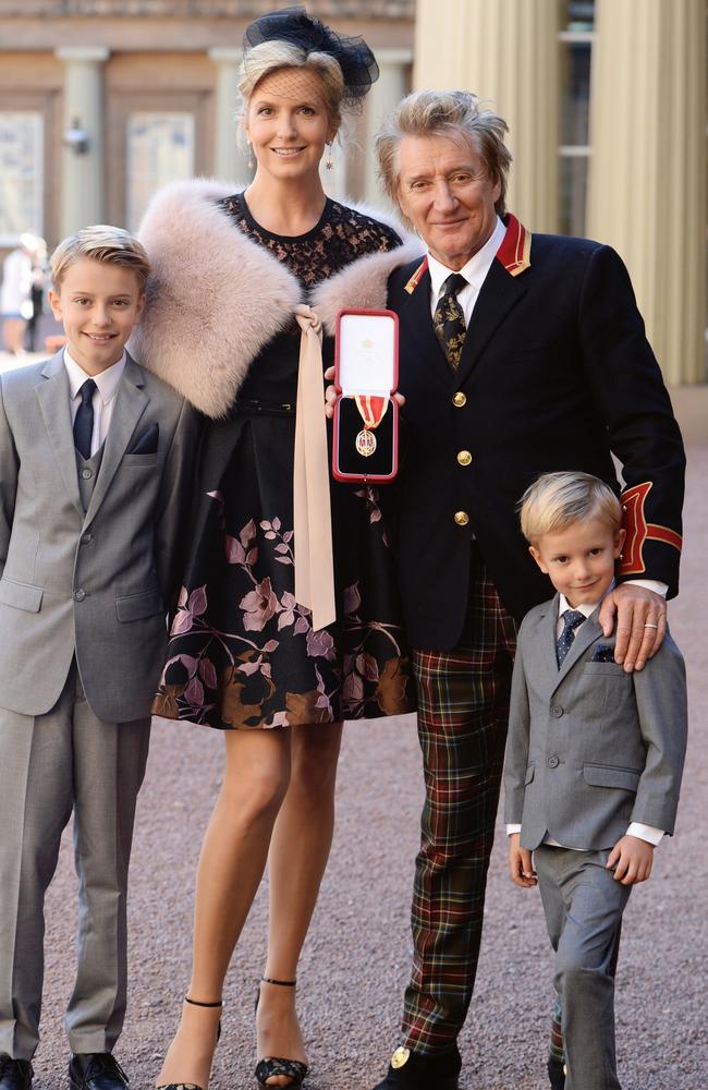 Sir Rod Stewart at his investiture at Buckingham Palace with wife Penny Lancaster and children Alastair and Aiden Stewart. Picture: Getty Images.